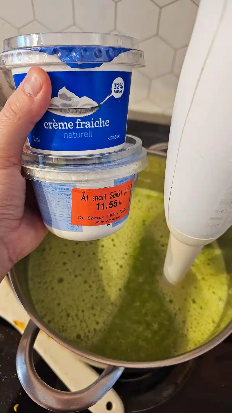 Tips för att spara pengar på mat: Hand håller i creme fraiche förpackningar med nedsatt pris, perfekt för billig matlagning.